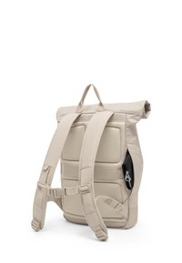 Beige roll-top backpack shown from back with padded straps, mesh back panel, chest buckle, and a partially visible black zippered side pocket.