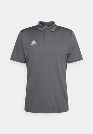 Dunkelgraues Adidas Polo-Shirt mit kurzen Ärmeln, drei Knöpfen und weißem Adidas-Logo auf der linken Brust.