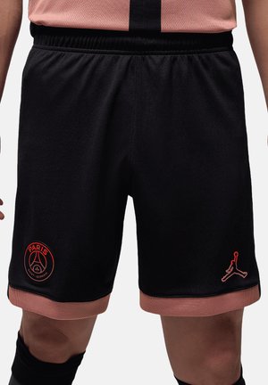 Shorts sportivi neri con fascia elastica in vita, dotati del logo rosso del Paris Saint-Germain e del logo Jumpman. Tessuto morbido, con dettagli a contrasto in rosa.