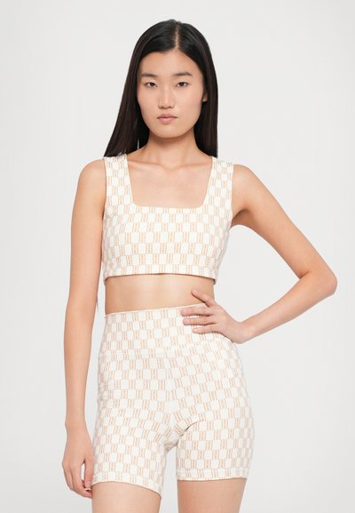 Two-piece set featuring a square neck crop top and high-waisted shorts. The fabric is cream with a brown geometric pattern.