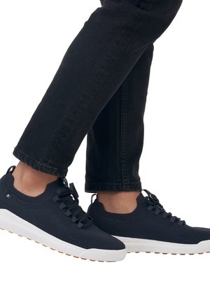 Navy mesh sneakers with white rubber soles, featuring textured uppers, rounded shape, and six lace eyelets for secure fit.