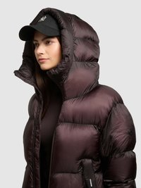 Dark purple puffer jacket with a high collar, quilted design, and a glossy texture. Features a front zip and side pocket. Black cap worn above.