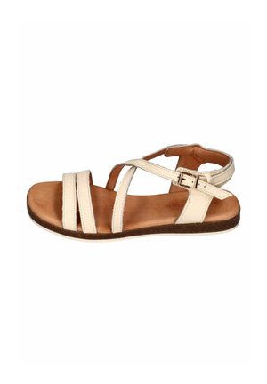 Beige leather flat sandal with three front straps, one ankle strap with buckle, and brown cushioned footbed.