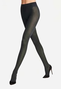 Collants noirs à motifs en matière transparente, présentant un design géométrique, avec une texture lisse et une taille haute pour un ajustement parfait.