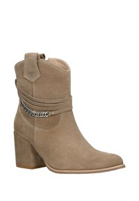 Světle béžové semišové kotníkové boty s blokovým podpatkem, bočním popruhem a řetízkovým detailem. Kulatá špička a poutko pro snadné obutí.