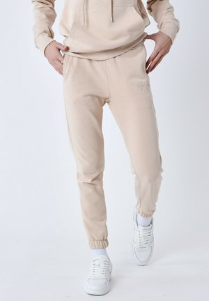 ESSENTIALS - Pantalon de survêtement - beige