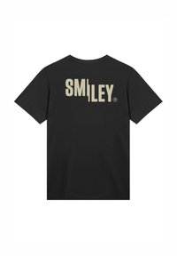Schwarzes Baumwoll-T-Shirt mit einem großen beige "SMILEY"-Logo, das auf den Rücken gedruckt ist. Standard-Design mit kurzen Ärmeln und Rundhalsausschnitt.