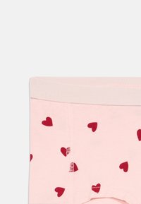 Ροζ βαμβακερό εσώρουχο με κόκκινες καρδιές, με μαλακή ζώνη και λεία υφή, σχεδιασμένο για άνεση και εφαρμογή.