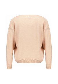 Pull à col rond surdimensionné en pêche avec un ourlet et des poignets côtelés. Texture douce, manches larges et un détail de bouton unique au dos du col.