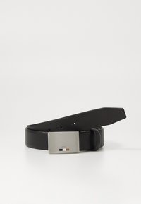 Black leather belt with a rectangular silver metal buckle featuring a logo and three color accents: white, black, and brown.