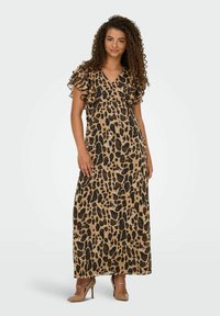 Maxi dress in stampa leopardato, realizzato in tessuto leggero, con scollo a V e maniche a strati con volant. Base beige con macchie nere.
