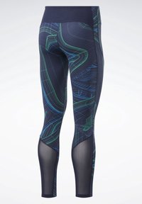 Leggings a fantasia navy con linee geometriche verdi e blu. Il design include pannelli in rete trasparente lungo le gambe inferiori.