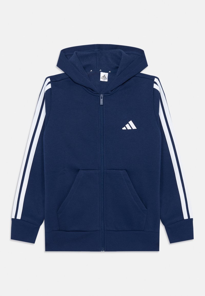 Marineblauwe rits hoodie gemaakt van zachte stof met witte strepen op de mouwen, twee voorzakken en een capuchon. Bevat het Adidas-logo in het wit.