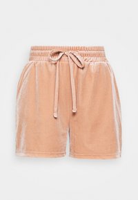 Pantalones cortos de terciopelo color durazno suave con cinturilla elástica y cordón atado en la parte delantera, estilo casual.