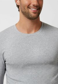 Gray long-sleeve shirt made of a soft, lightweight fabric with a round neckline and casual fit, featuring a smooth texture and minimal stitching.