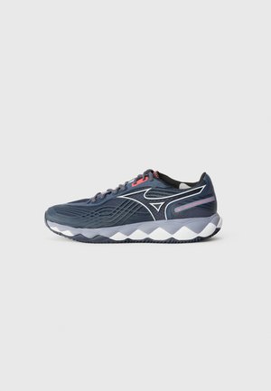 Navy running shoe with textured upper, white wavy sole, and red accent. Features a lace-up design and logo on the side for branding.