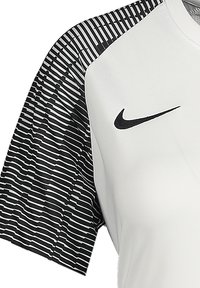 Maglietta sportiva bianca con maniche corte a strisce nere e logo Nike nero sul davanti. Il tessuto ha una texture liscia e leggera.