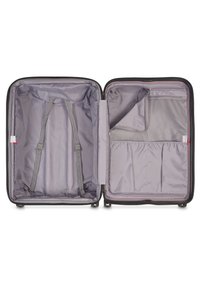 Valise rigide noire ouverte, dévoilant un intérieur doublé de gris avec des sangles, une poche zippée et des compartiments en filet pour l'organisation.