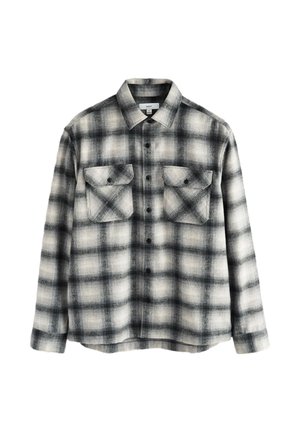 Black and white plaid flannel shirt with two chest pockets, button closure, spread collar, and a soft, textured fabric.