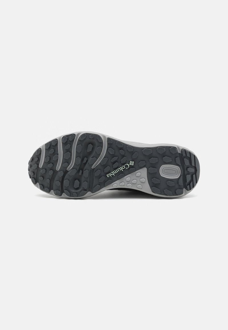 Columbia Wanderschuhsohle in Schwarz und Grau aus Gummi. Verfügt über ein strukturiertes Profil mit hexagonalem und rundem Grip. Logo gut sichtbar.