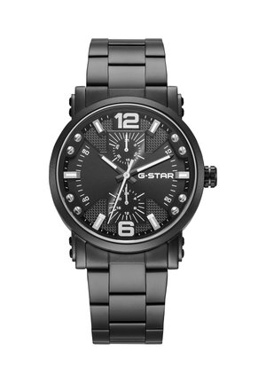 Montre-bracelet en métal noir avec grands chiffres 12 et 6, marqueurs d'heure blancs, trois sous-cadrans et logo G-STAR sur le cadran.