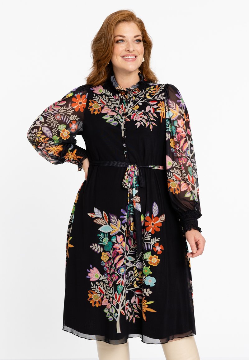 Schwarzes Kleid mit floraler Bestickung in lebhaften Farben, durchsichtige Ärmel, eine taillierte Taille mit einer Schleife und Knopfdetails am Ausschnitt.