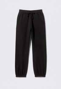 Pantalons de survêtement noirs en tissu doux, avec une taille élastique à cordon de serrage, des poches latérales et des poignets élastiques aux chevilles.