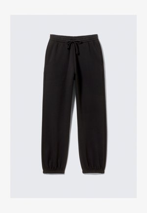 Pantalons de survêtement noirs en tissu doux, avec une taille élastique à cordon de serrage, des poches latérales et des poignets élastiques aux chevilles.