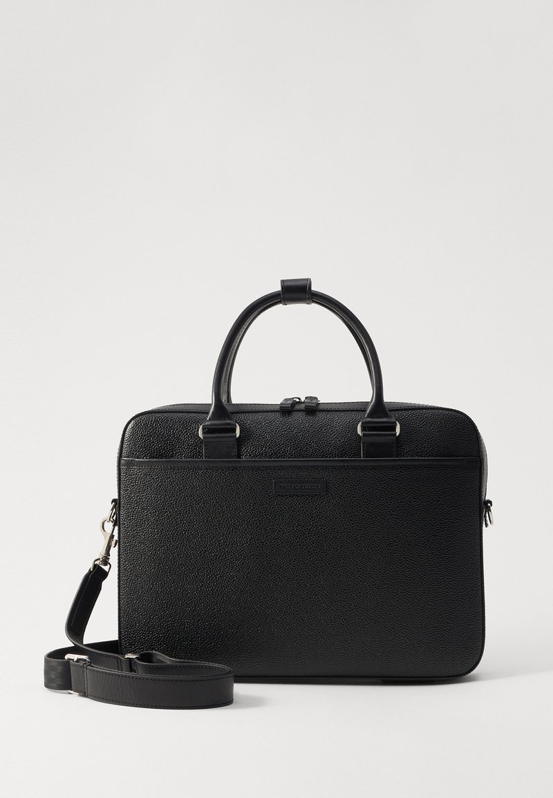Black leather briefcase with a textured finish, dual top handles, detachable shoulder strap, and a rectangular shape. Silver hardware accents.