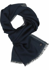 Écharpe bleu marine faite d'un tissu léger et doux, avec des bords effilochés et un petit accent en métal d'un côté. Tordue en boucle.