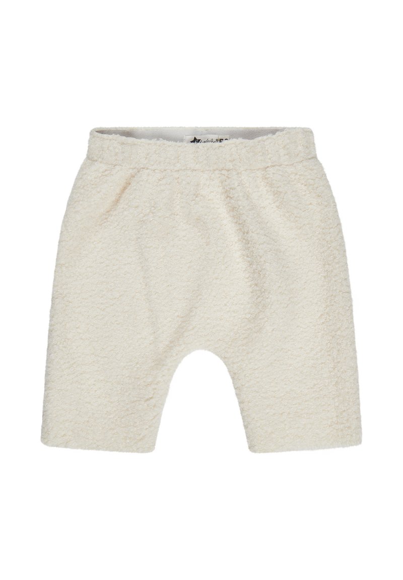Cream-colored, plush shorts made of textured fabric with an elastic waistband and loose fit, featuring a rounded hem and casual design.