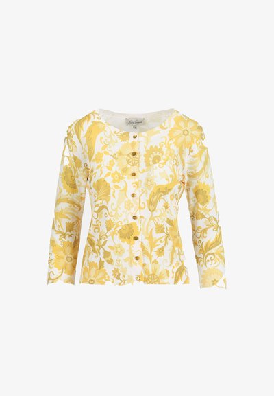 Cardigan blanc avec motif floral et feuilles jaunes, col rond, manches longues et rangée de petits boutons jaunes sur le devant.