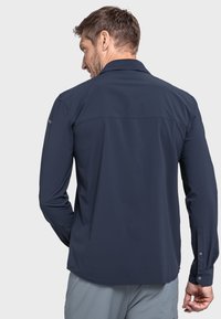 Marineblaues Langarmhemd mit strukturiertem Kragen, Knopfmanschetten und abgerundetem Saum, aus leichtem, glattem Stoff gefertigt.