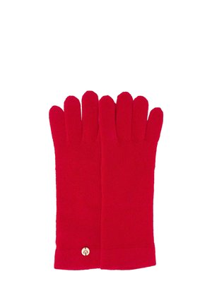 Pair of bright red knitted gloves with a small round beige tag near the wrist on a white background.