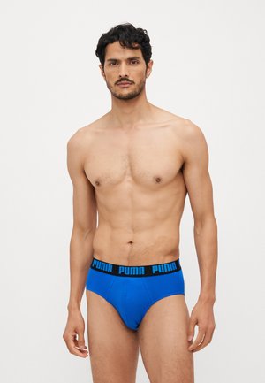 Blaue Baumwollunterhosen mit einem schwarzen Bund, der das "PUMA"-Logo in Blau trägt. Das Design ist klassisch und bietet eine figurbetonte Silhouette.