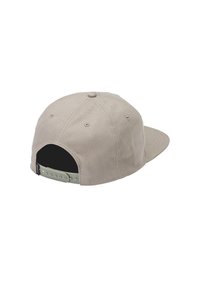Beige snapback cap with a flat brim, fabric exterior, and adjustable plastic strap. Features ventilation eyelets and a contrasting black interior.