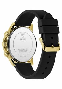 Cinturino in silicone nero con cassa in acciaio inossidabile dorato. Forma rotonda con retro inciso, dotato di dettagli sulla resistenza all'acqua.