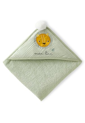 Light green baby hooded towel with an embroidered yellow lion face, white pom-pom on the hood, and "mon lion" text below the lion.