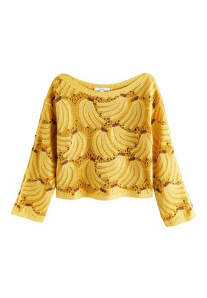 Žlutý háčkovaný top s dlouhým rukávem s otevřeným vzorem tkaní, zdobený shluky banánů v odstínech žluté a hnědé.
