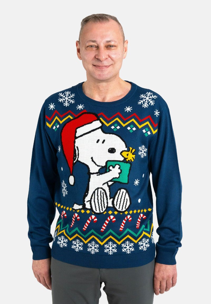 Sweater features a navy blue knit with a festive Snoopy design. Accents include snowflakes, candy canes, and a red Santa hat.