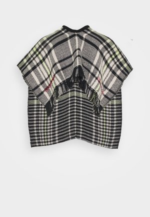 Poncho à carreaux noir, blanc et vert avec des bords à franges et un texte rouge brodé de chaque côté, présenté sur un fond blanc uni.