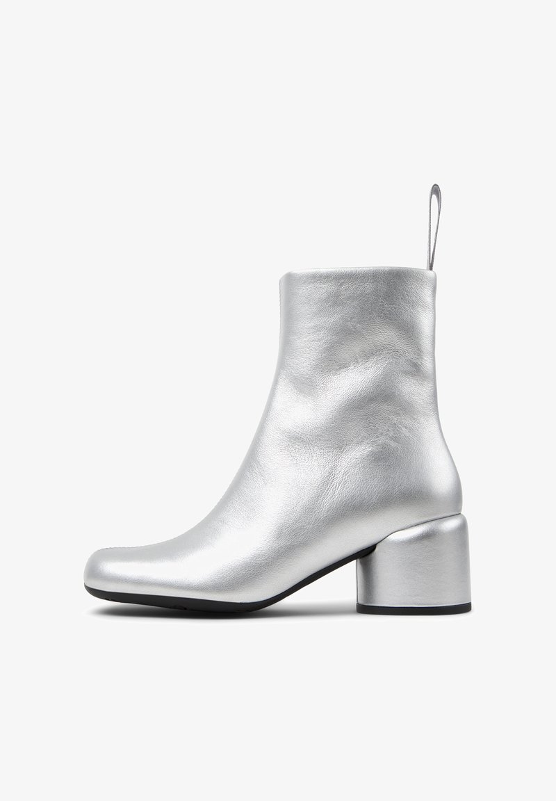 Silver leather ankle boot with a rounded toe, a smooth texture, and a cylindrical block heel. Features a rear loop for easy wear.
