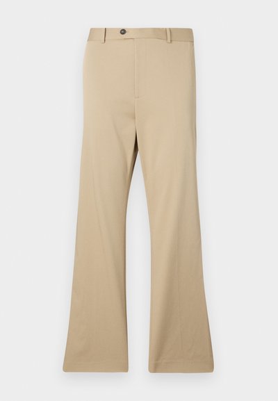 Beige flared trousers made of smooth fabric. Features a button closure, front pockets, and a tailored fit through the hips, extending to a wide leg.