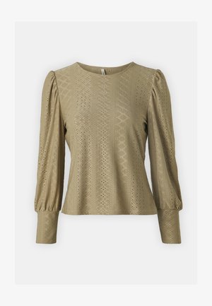 Beige long-sleeve top featuring a round neck, textured fabric with geometric cutouts, and voluminous puff sleeves. Smooth, soft texture.