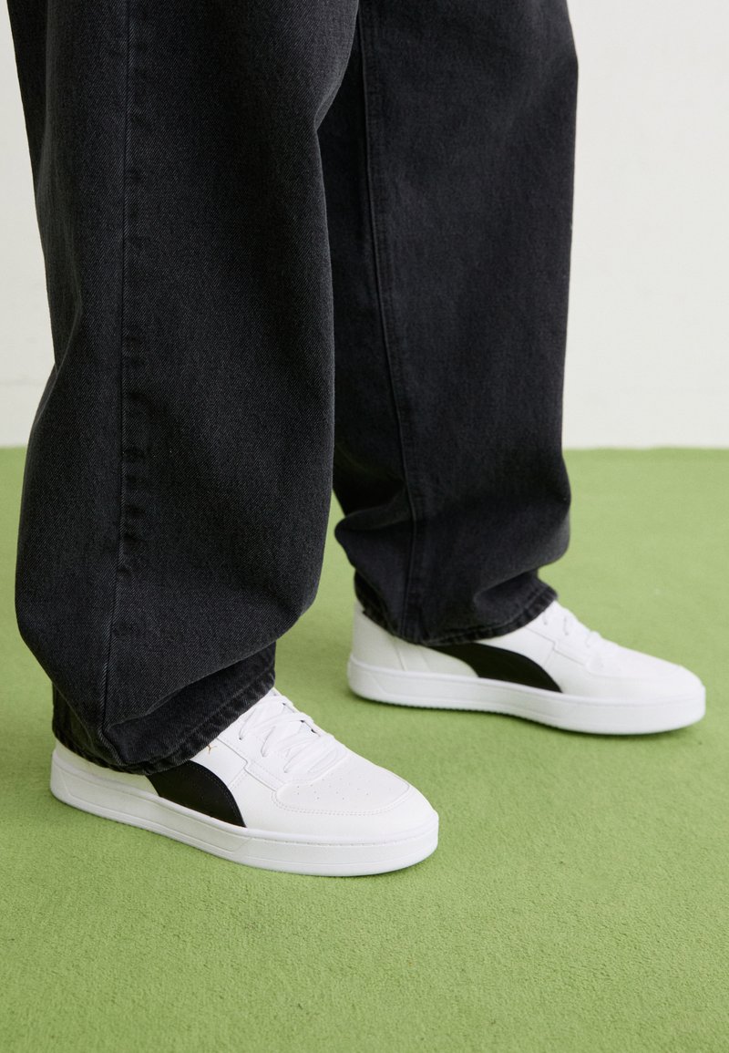 Puma CAVEN Trainers white/black/gold/white Zalando