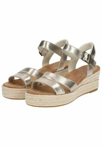 Metallic silver wedge sandals with multiple straps, a textured espadrille sole, and a cushioned footbed for comfort.