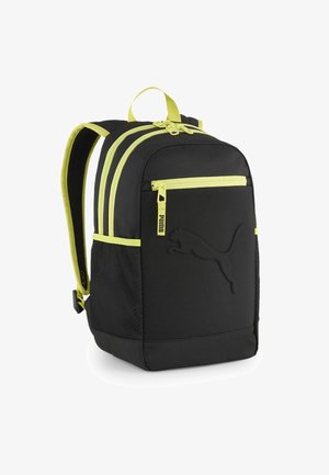 Black backpack with yellow accents, featuring three zippered compartments, mesh side pockets, and a prominent Puma logo on the front.