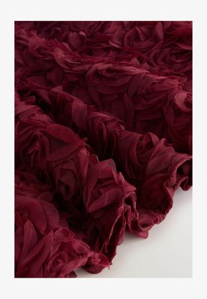 Burgundy floral fabric featuring layered, overlapping petals made of lightweight mesh, creating a textured, three-dimensional appearance.