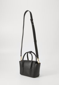 Black textured leather handbag with dual top handles and a removable shoulder strap. Features gold hardware and a structured shape.