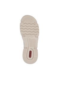 Semelle en caoutchouc blanche avec un motif de relief en zigzag, avec un accent de logo rouge et un talon texturé. Les éléments visuels indiquent traction et soutien.